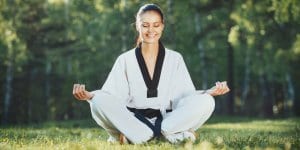 Martial Arts Lessons for Adults in Flushing NY - Happy Woman Meditated Sitting Background